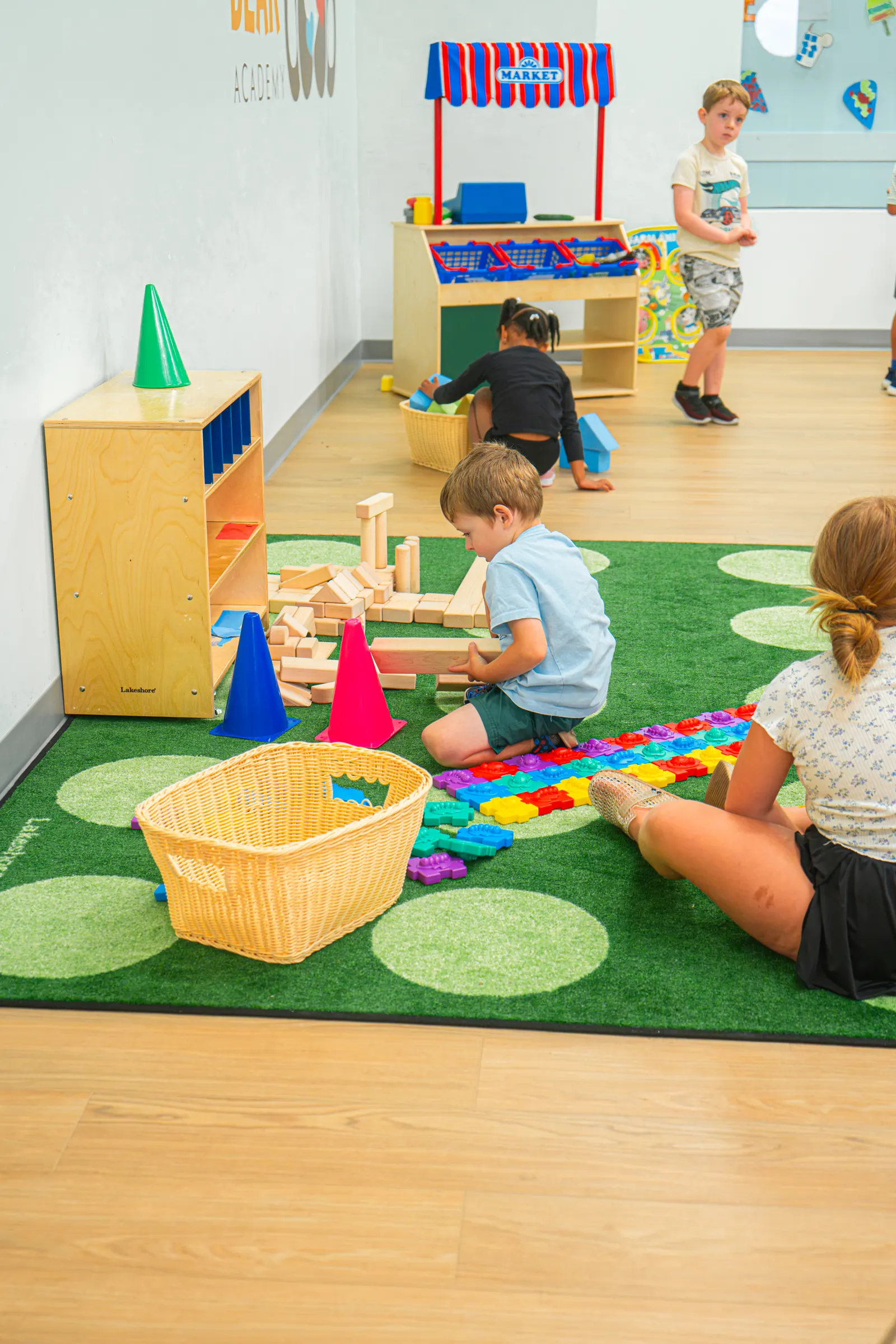 Children playing in a classroom with a garden play mat