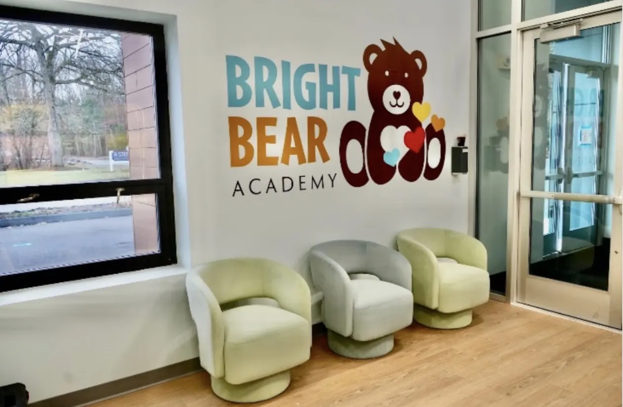 The Bright Bear Academy lobby with the bear logo on the wall
