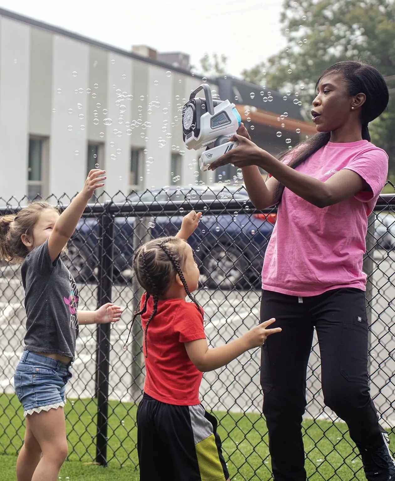 A Bright Bear teacher playing with children outside
