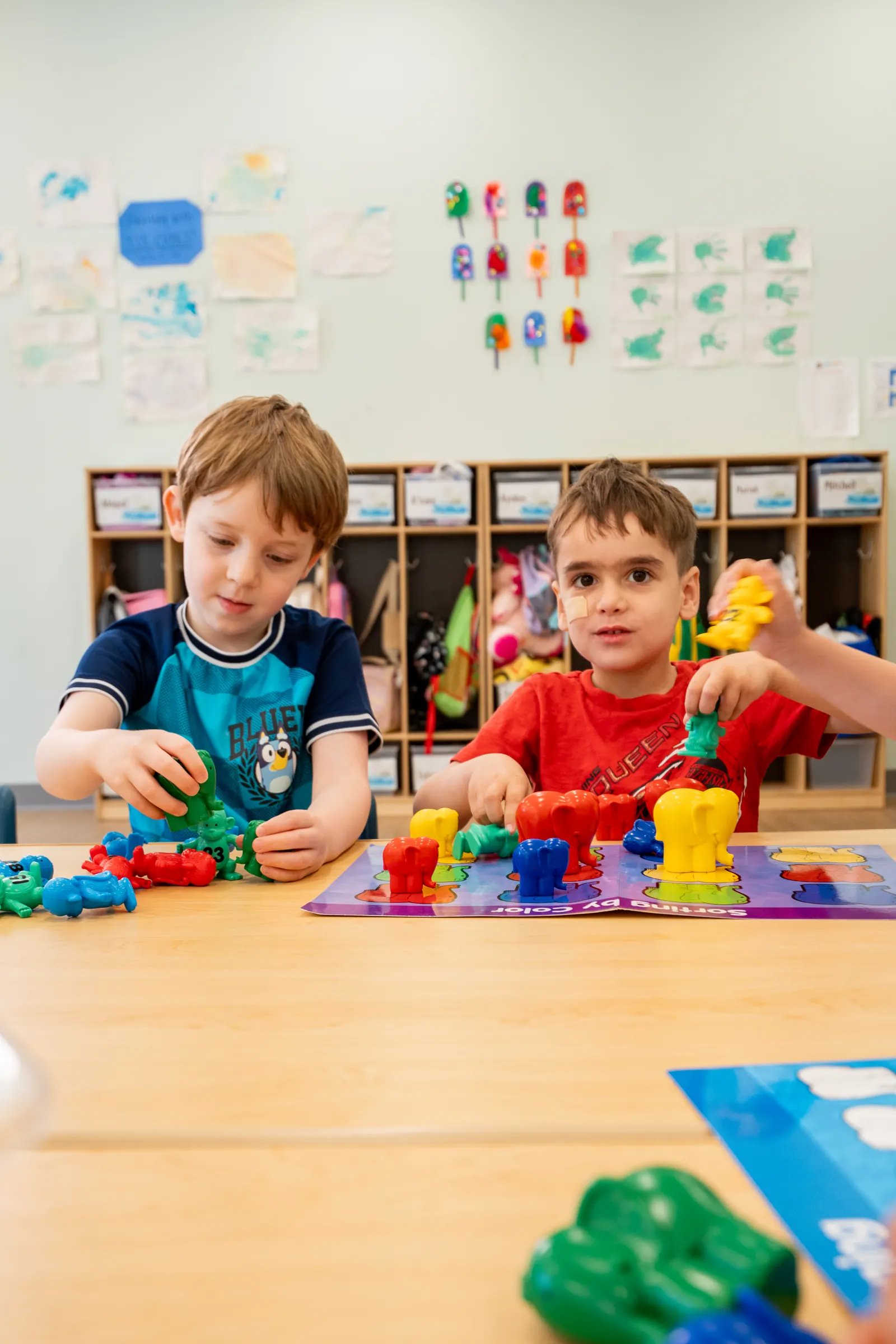 Two preschoolers building with colorful blocks