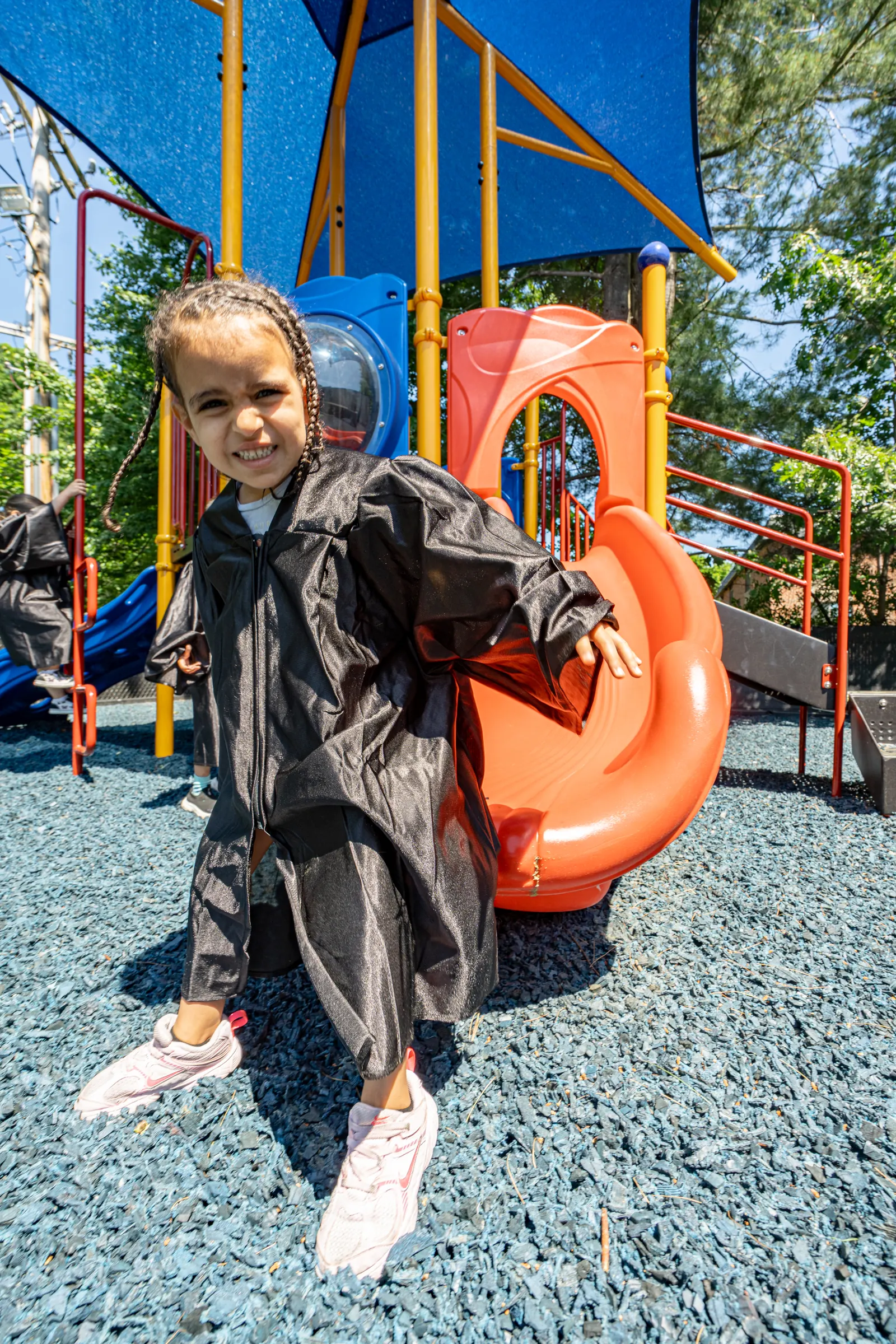 A child dressed up and playing on the playground