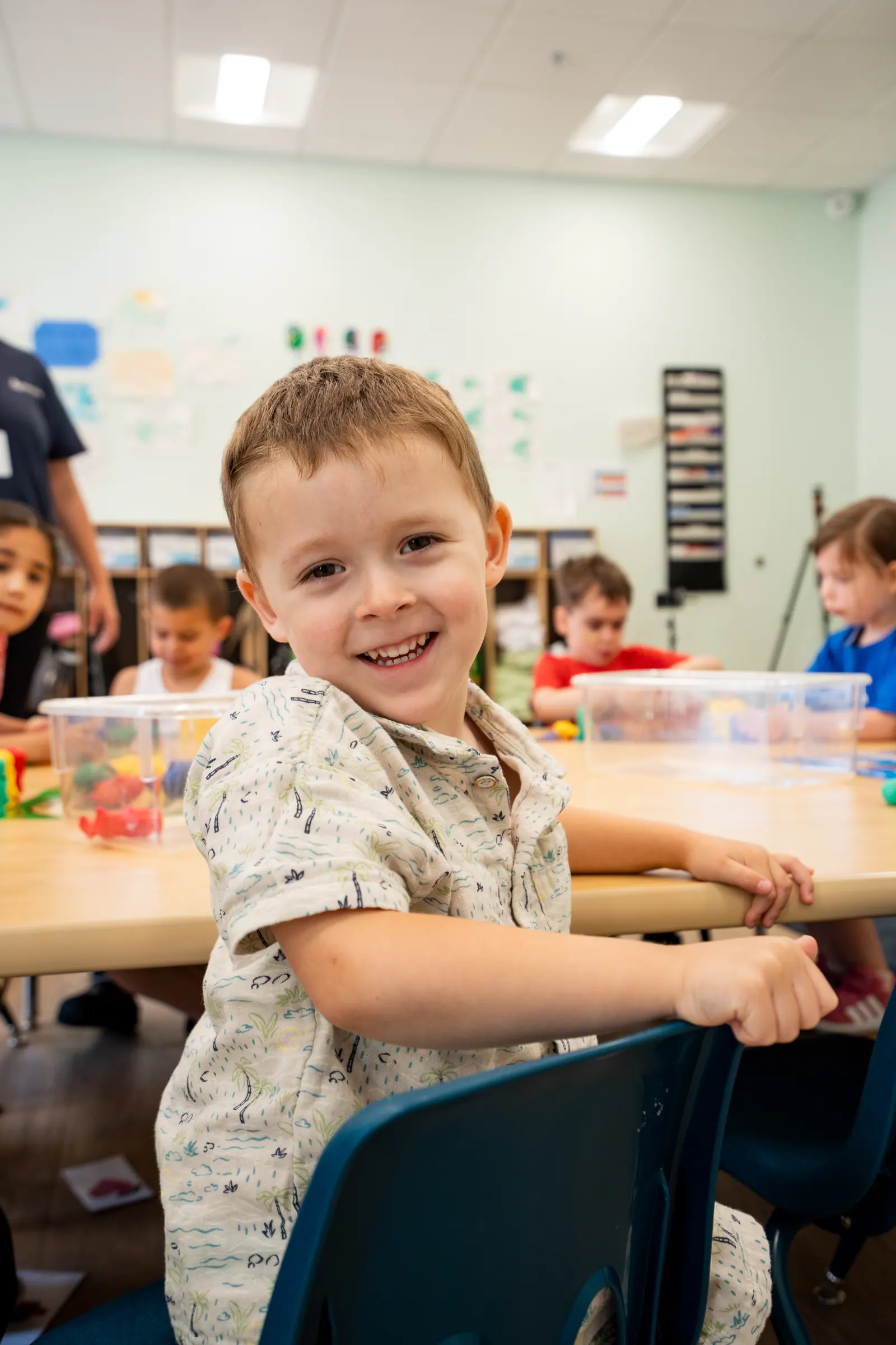 A preschooler smiling during table play